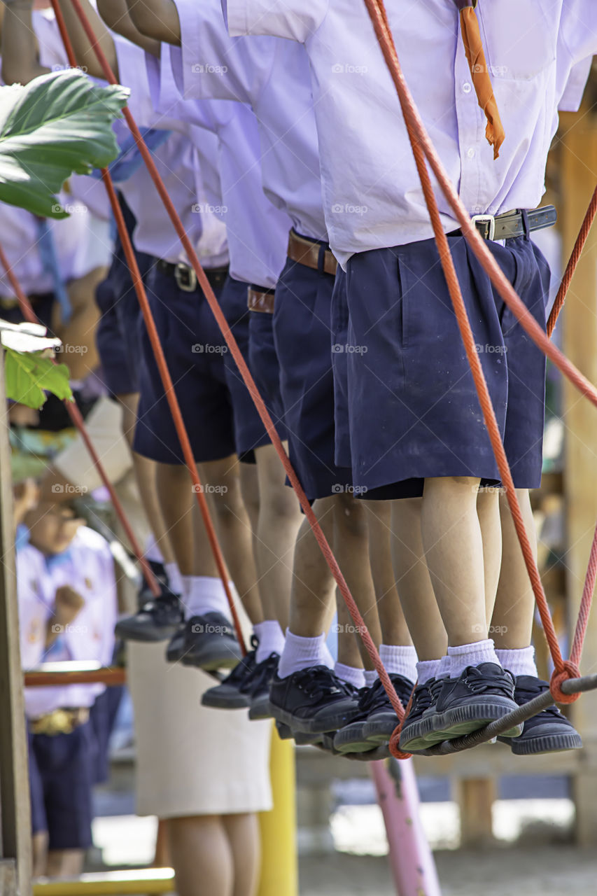 Children walking on the wire rope are doing the activity.