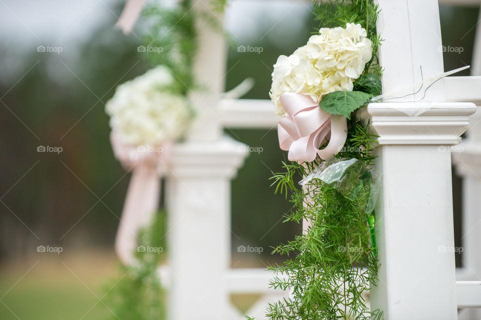 White Arbor Wedding Arch with White Hydrangeas and Pink Bows