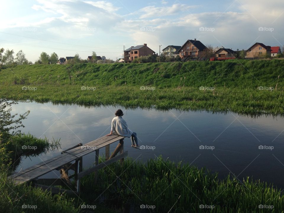 Girl alone at the riverside