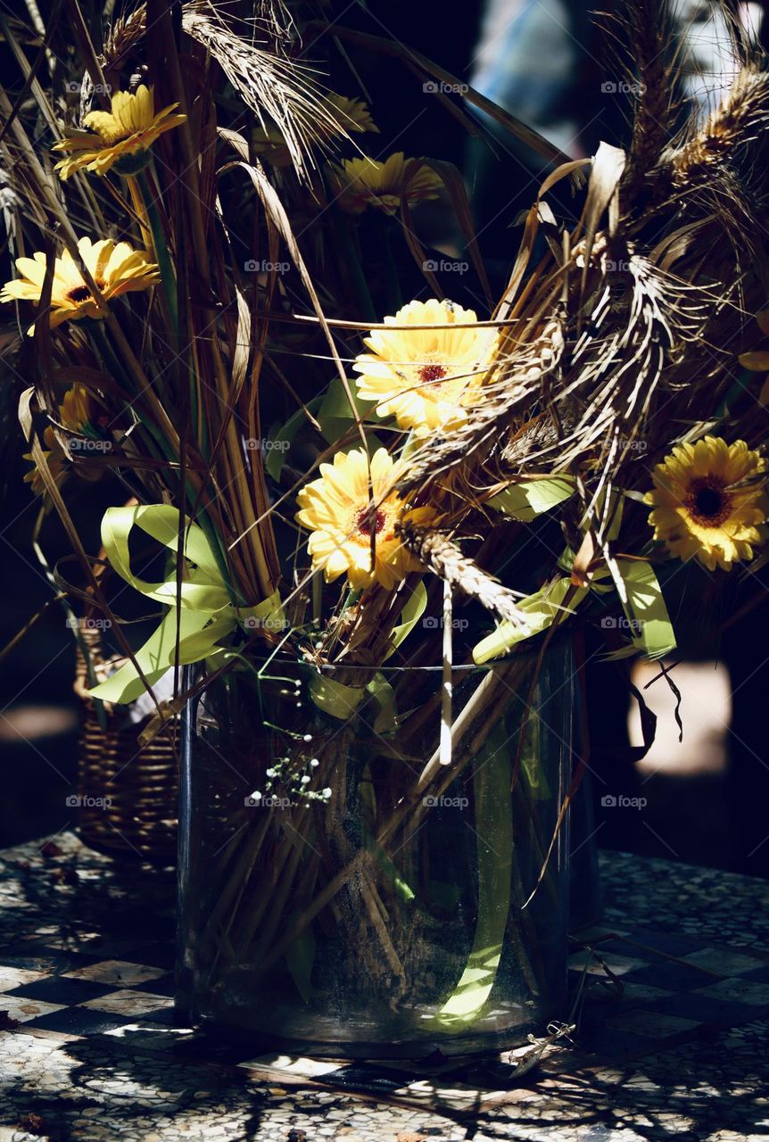 Yellow flowers and wheat stalks in a vase 