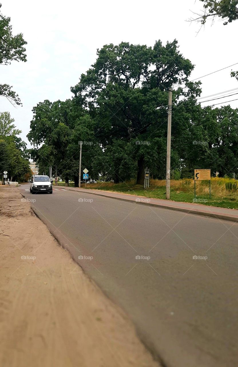An almost empty road on which one car drives іn work