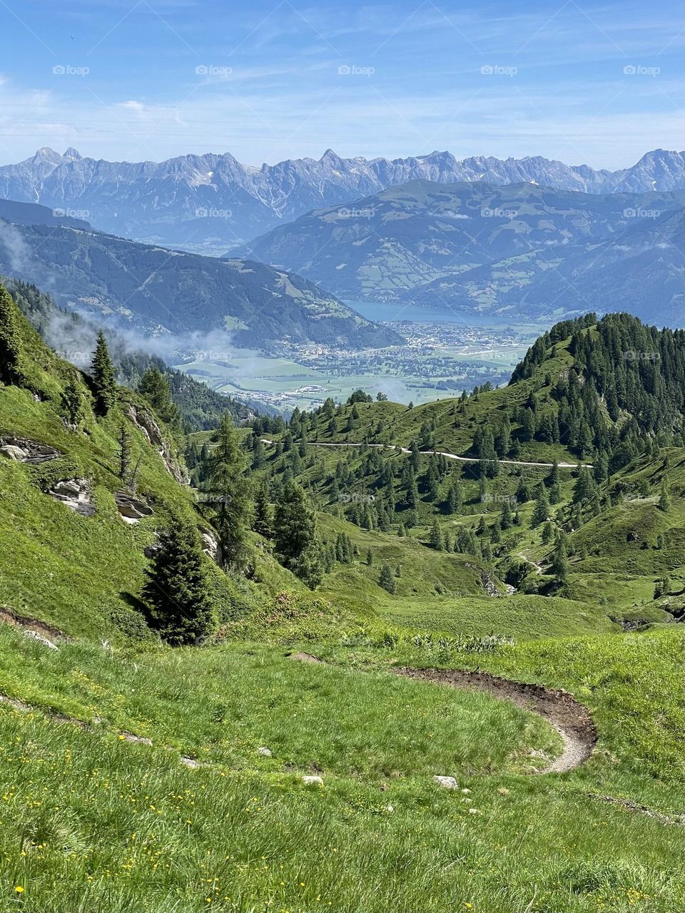 Panoramic view of mountains and hiking trail in the Alps of Austria on a sunny summer day 