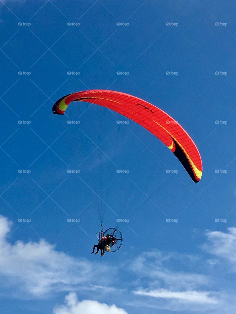 practicing paraglider on the beach