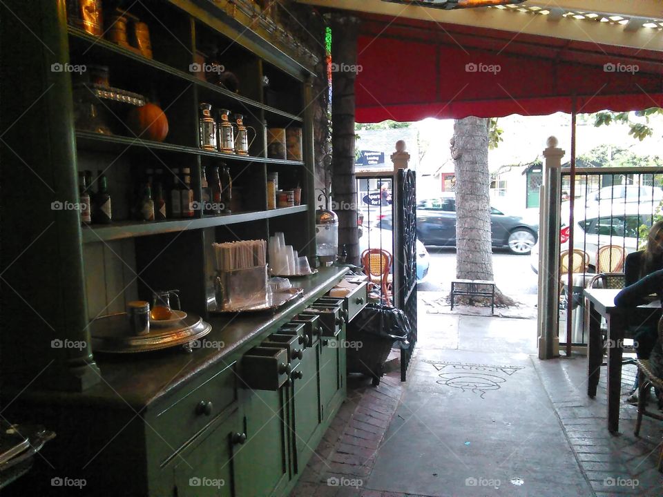 a shot from inside the outdoor, protected/sheltered seating area of an interesting cafe/bakery, near LA