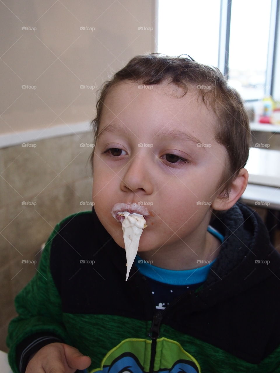 A little boy hilariously loses control of his vanilla ice cream as a giant bunch leaves the cone unexpectedly. 