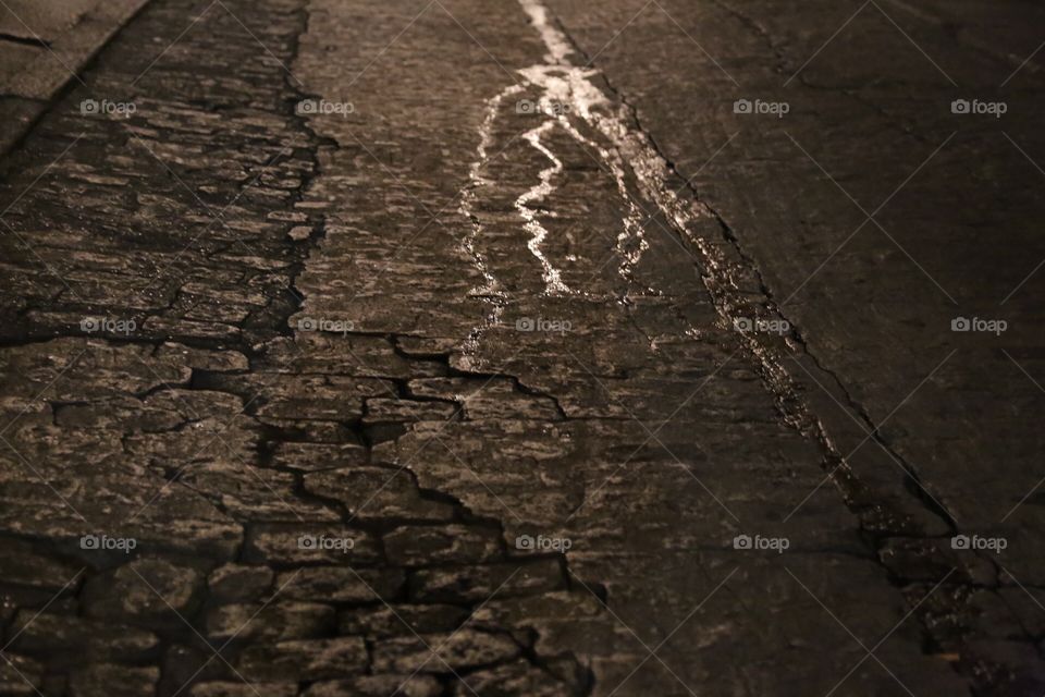 Water on the street reflecting in the night