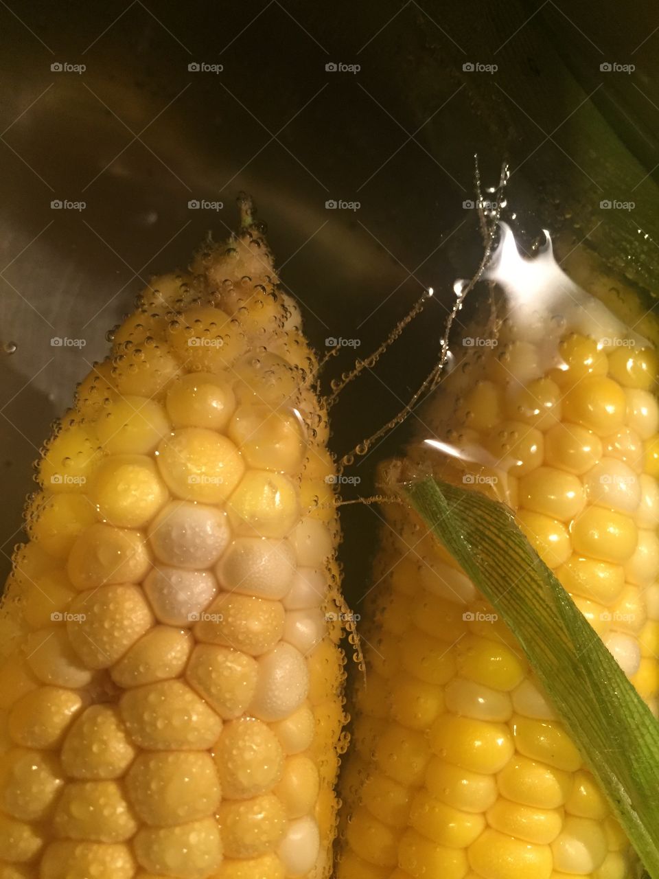 Boiling corn in hot water with bubbles