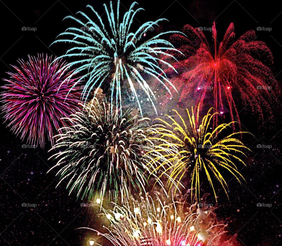 Dazzling multicolored fireworks bursting into the night sky.