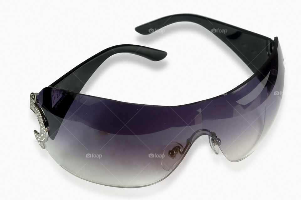 sporting dark glasses on black background