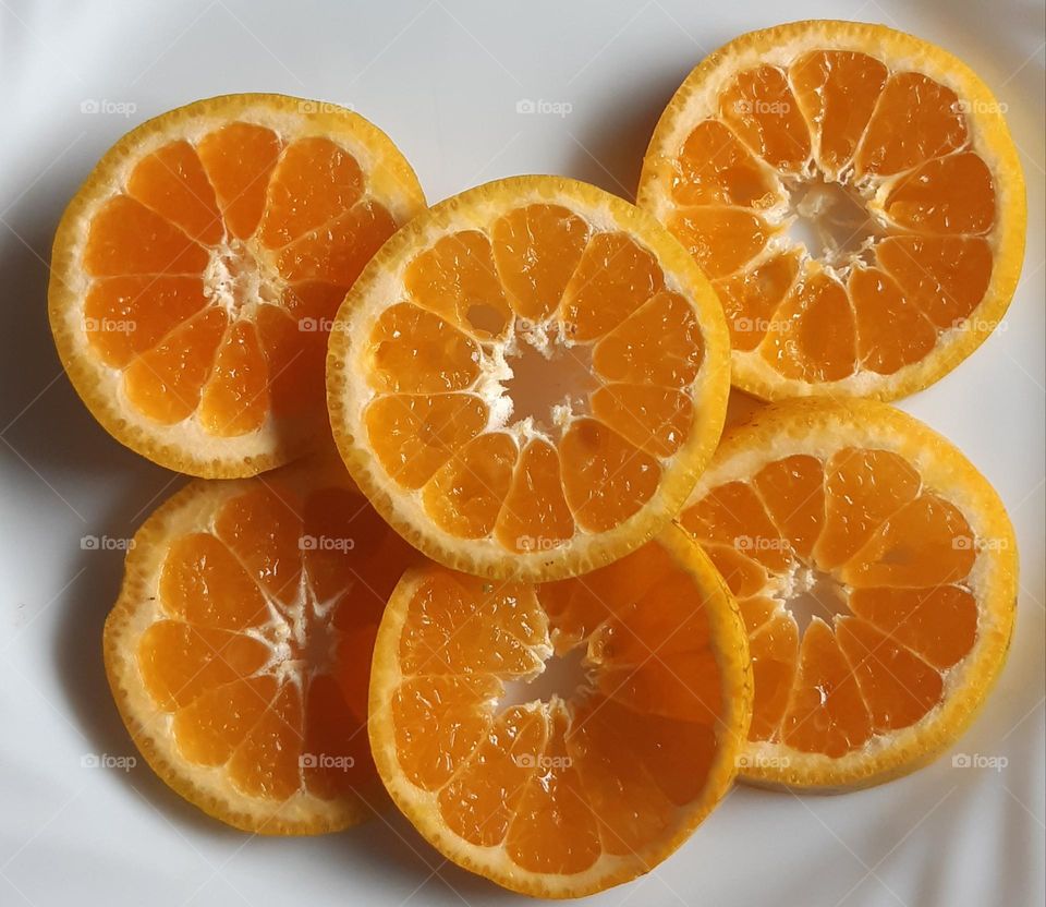 Slice of orange fruit isolated on white background