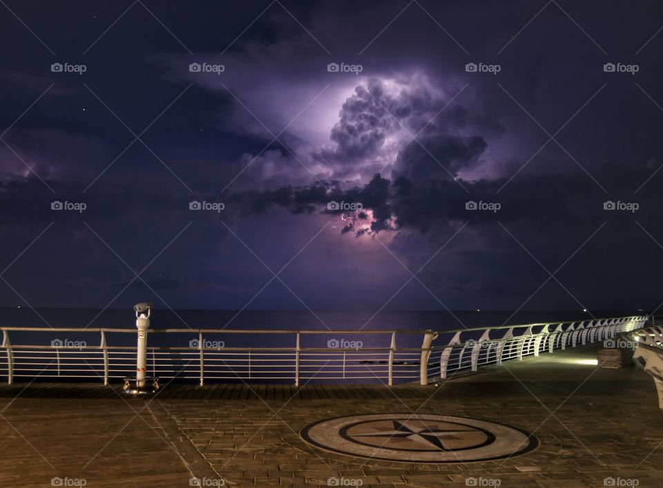 Thunderstorm and lightning over the sea at night