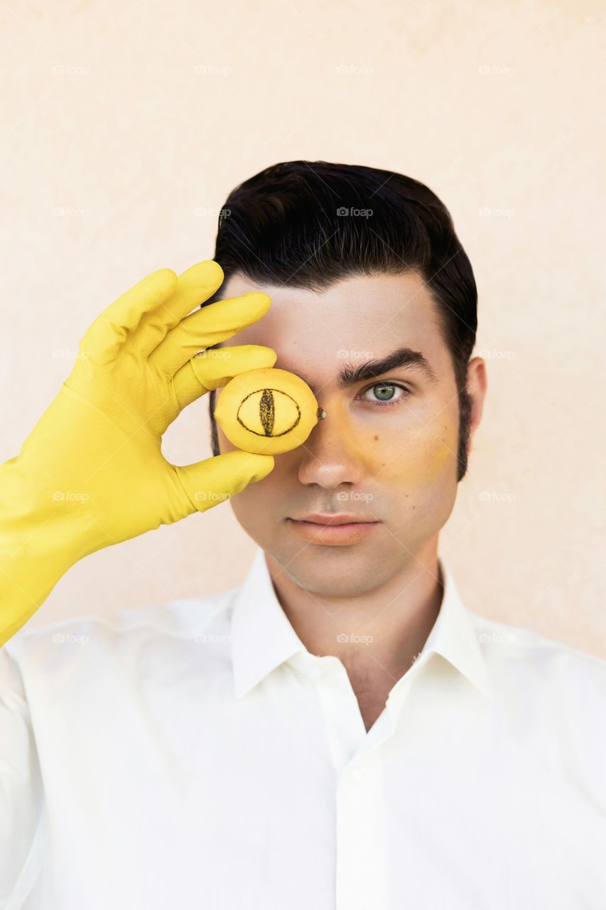 Man with yellow lemon and glove