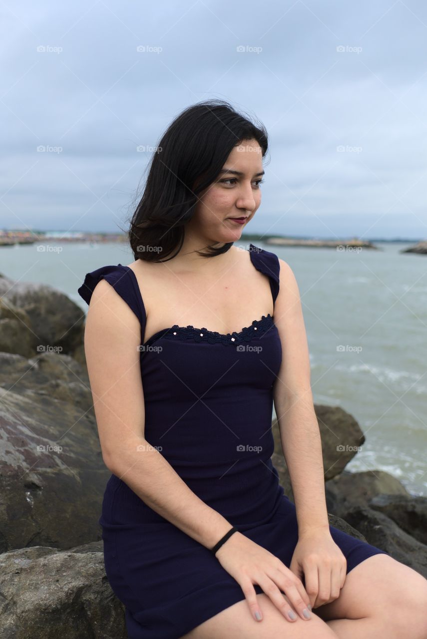 Young woman enjoys the solitude of the sea