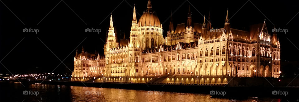 The Hungarian Parliament Building (Hungarian: Országház, pronounced [ˈorsaːkhaːz], which translates to House of the Country or House of the Nation), also known as the Parliament of Budapest for being located in that city,[1] is the seat of the National Assembly of Hungary, one of Europe's oldest legislative buildings, a notable landmark of Hungary and a popular tourist destination of Budapest. It lies in Lajos Kossuth Square, on the bank of the Danube. It is currently the largest building in Hungary[2]and still the tallest building in Budapest.