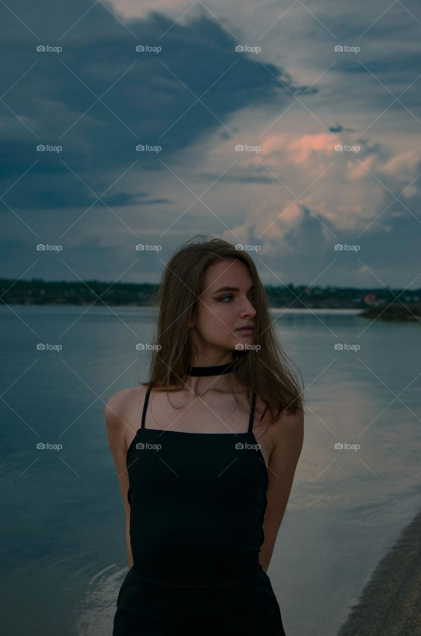 Girl on the background of a stormy sky