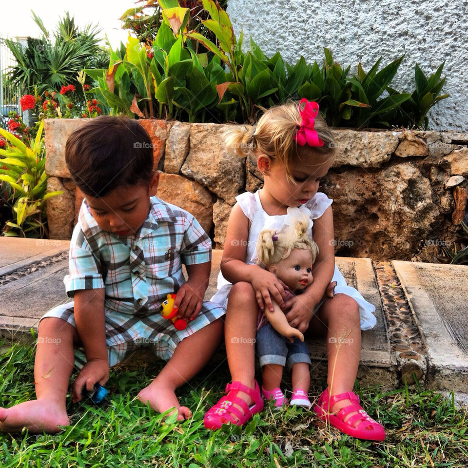 A boy an a girl playing at a party