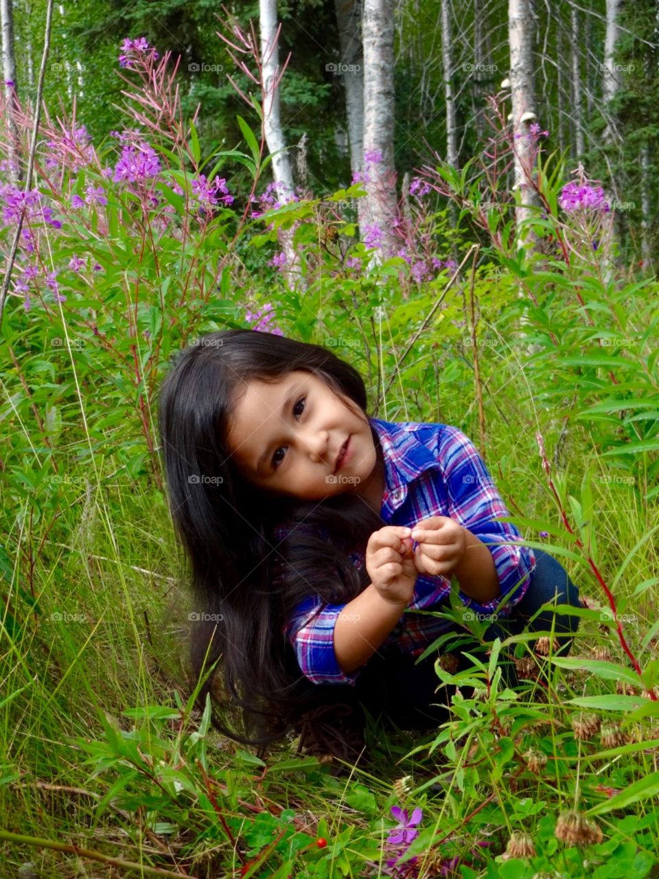 Cute little girl in flower field