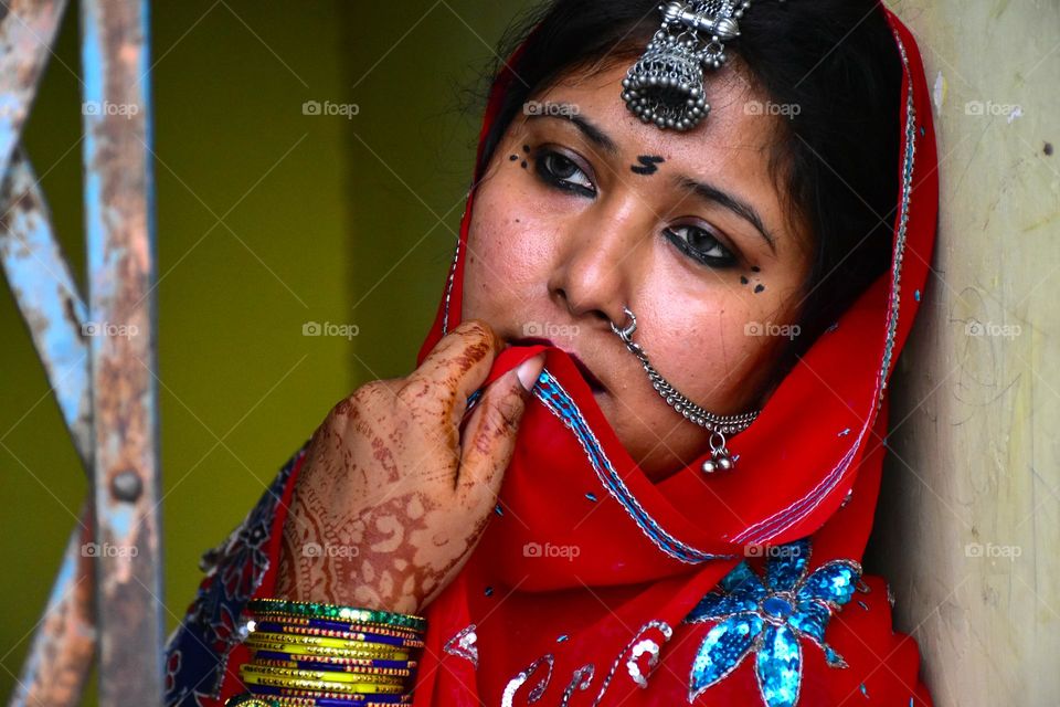 Traditional Rajasthani woman wearing saree and jewelry