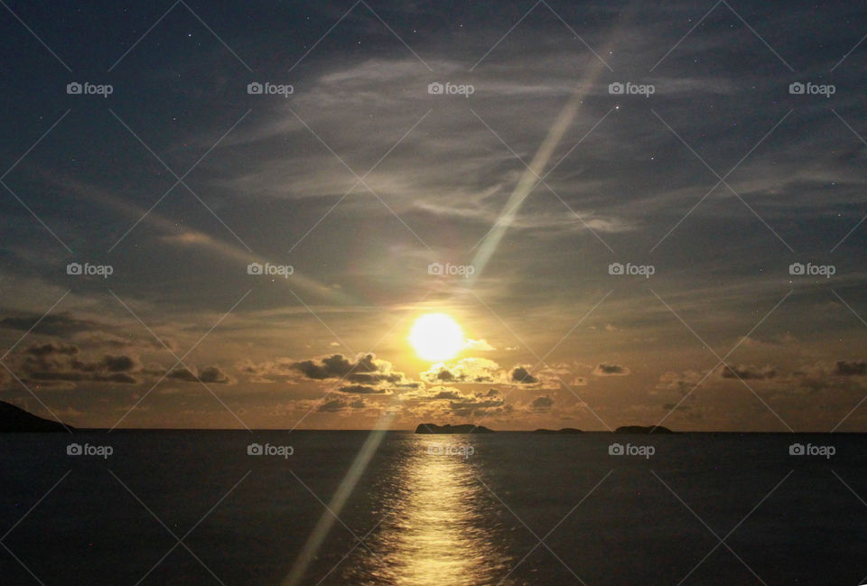 Golden hour in Koh Tao, Thailand. A beautiful colourful sunset, you can feel the peace and the local customs. Small boats.