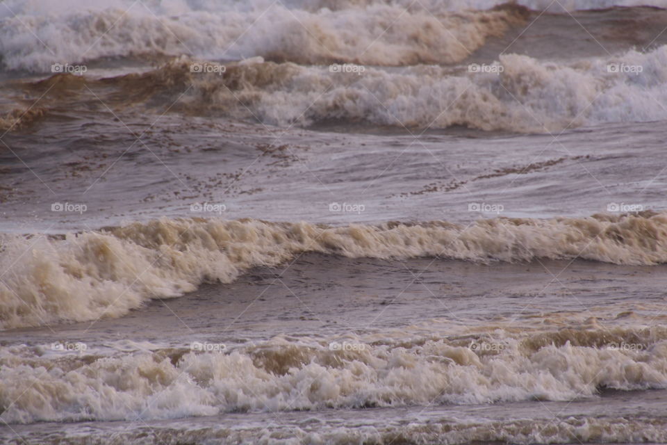 waves overlapping as they crash along the shoreline