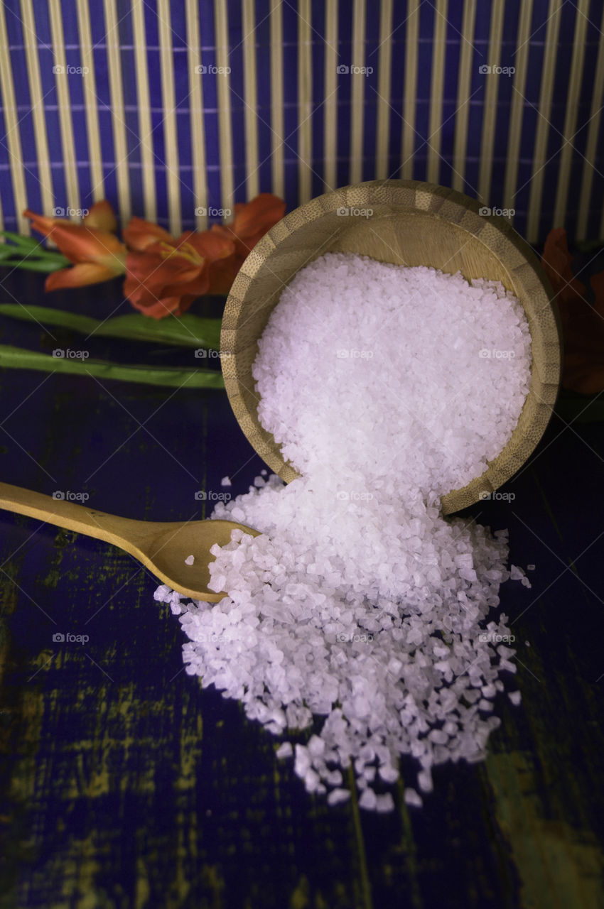 dropped salt in a table with wood spoon tropical style