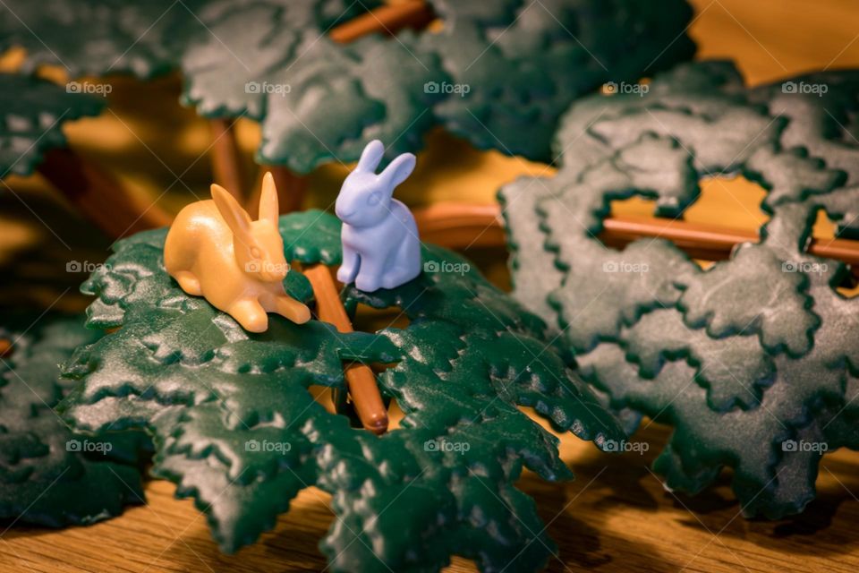 Two rabbits standing in a leaf