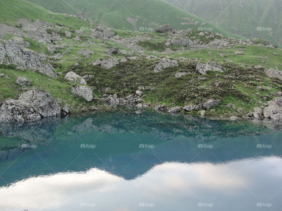 Reflection of hill on water