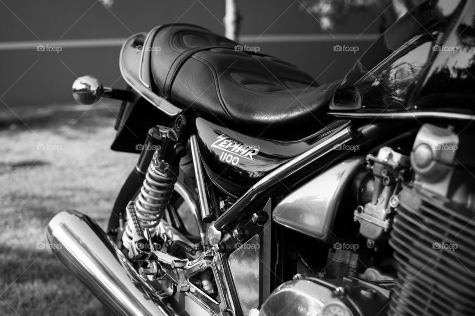 Kawasaki motorcycle. Close up shoot of kawasaki motorcycle in the garden. Engin and front of a bike. Black and white photo.