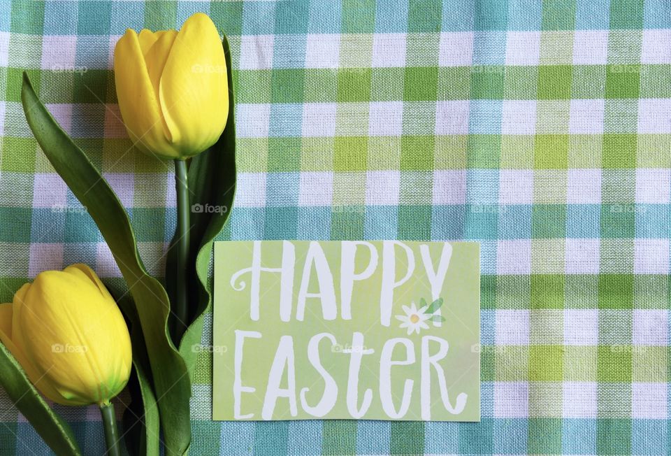 Happy Easter, yellow tulips on yellow and green plaid