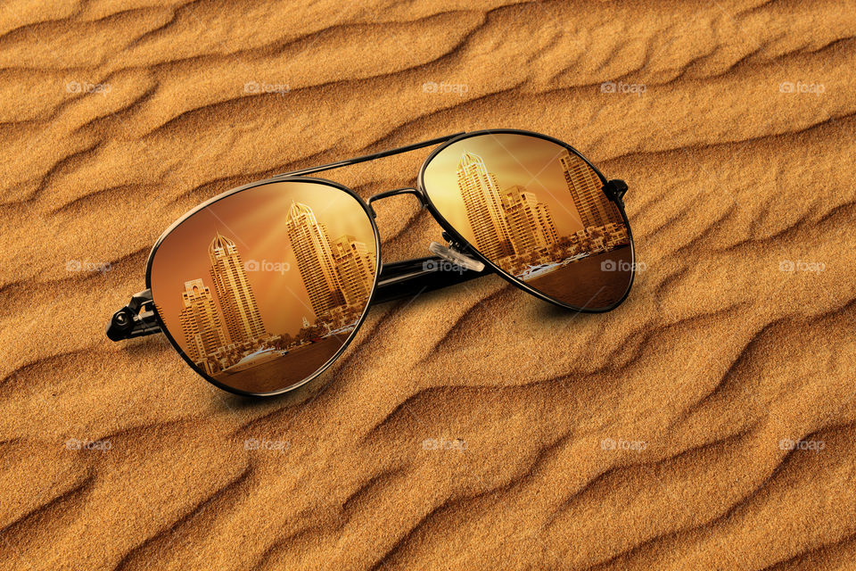 Dubai buildings reflected on sunglasses travel concept