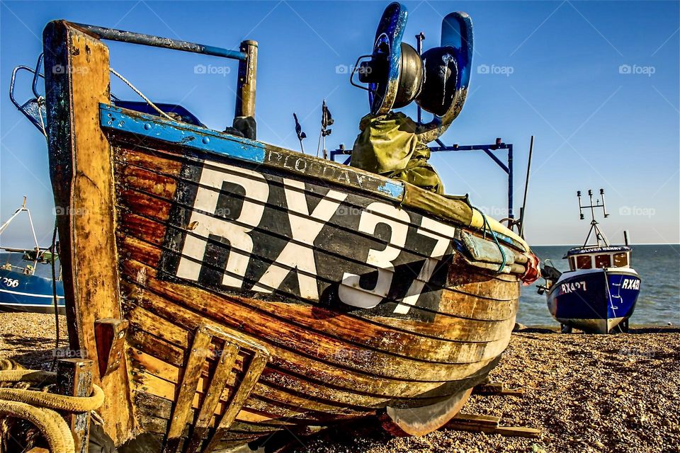 Working fishing boat RX37 on the pebbled fisherman’s beach, Rock-a-nor, Hastings UK 