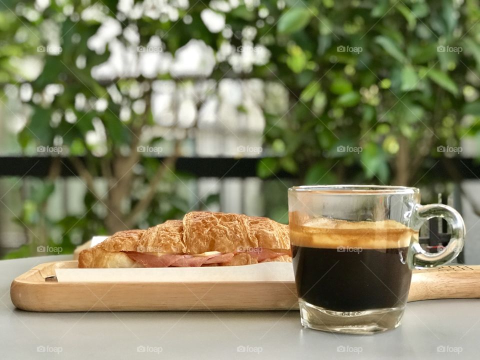Black coffee with croissant