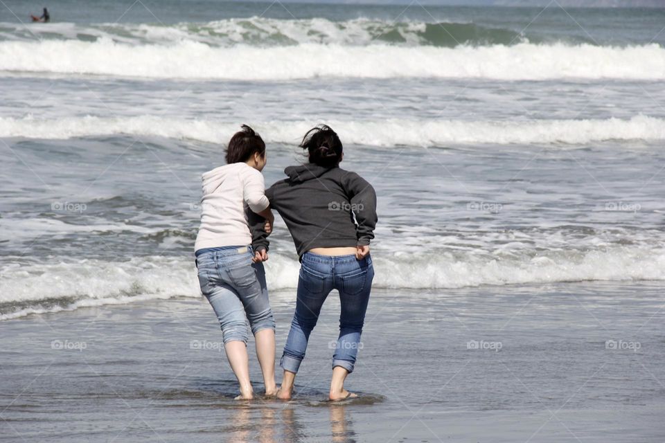 Playing girls at the ocean