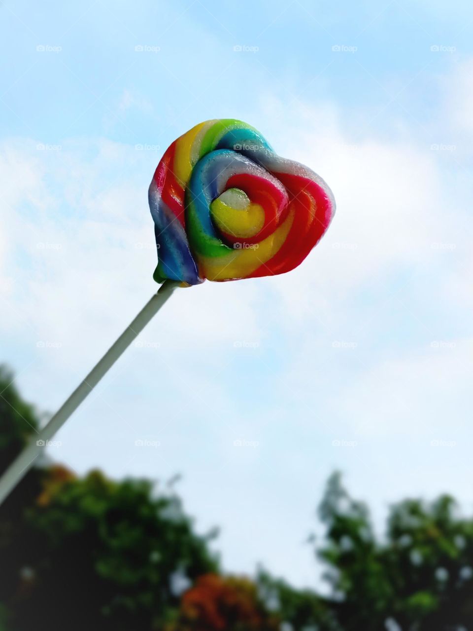 Rainbow candy and sky as background...