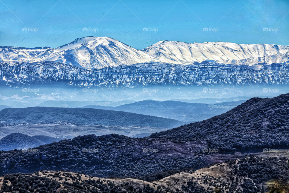 Snow-covered mountains above the clouds