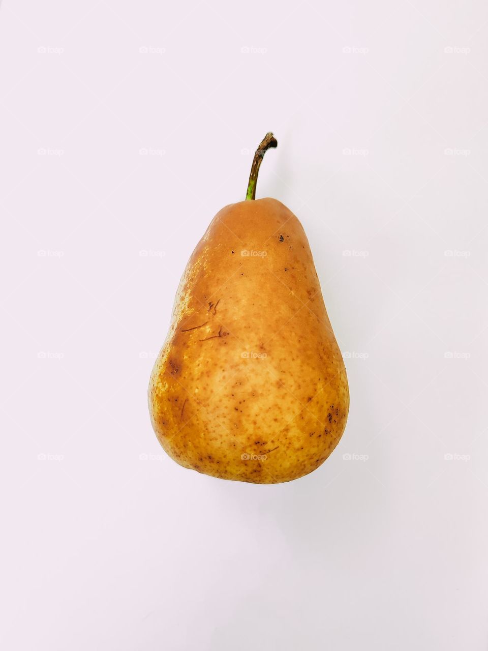 Ripe brown yellow pear fruit close up isolated side view