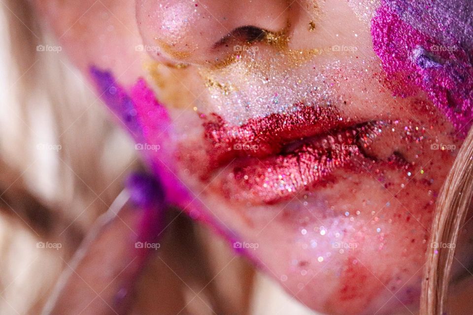 A child wearing glitter makeup