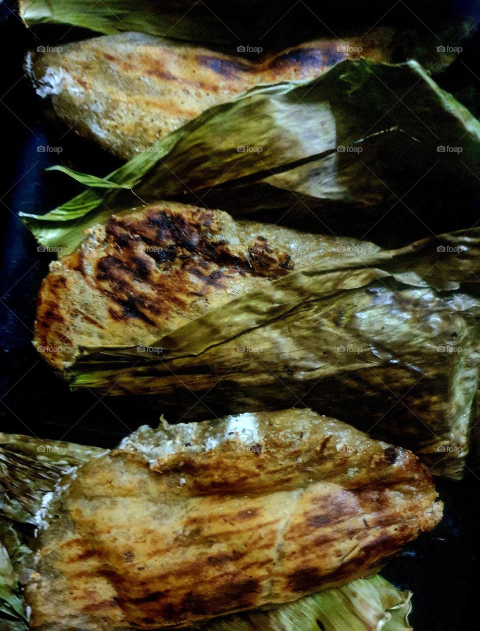 Traditional Banana Pancake Stuffed with Grated Coconut, Wrapped in Banana Leaves (Lempeng Pisang)