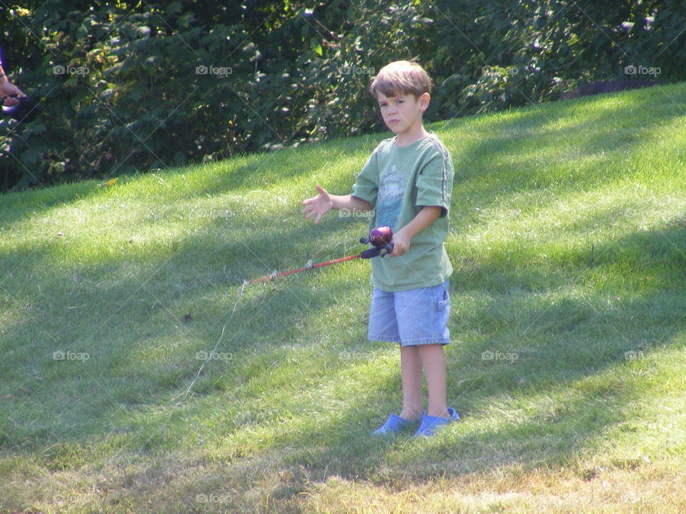 This boy just casted his line while fishing.