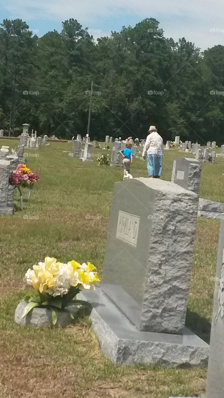 Grammie,  what is a cemetery?. Grammie and great grandson looking at Graves