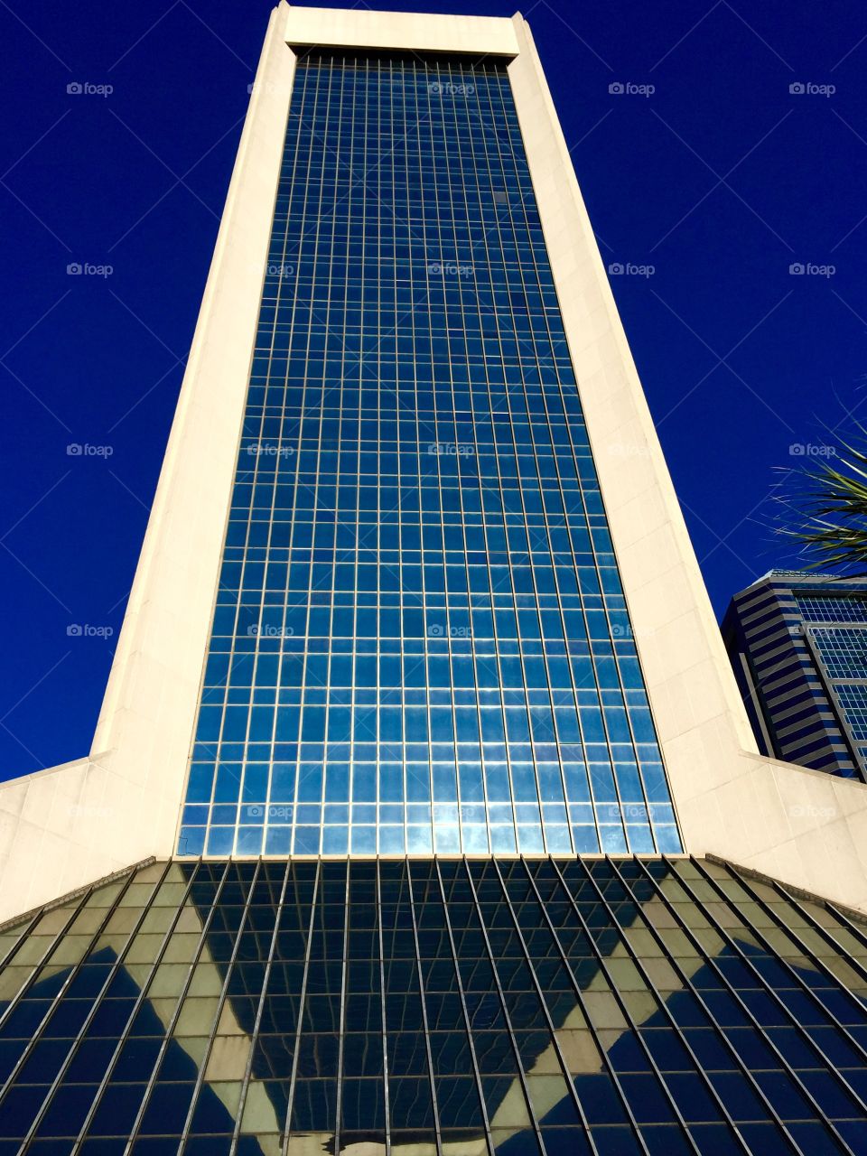 Building Reflects Itself. Building in downtown Jacksonville lower floors windows are at an angle and reflects upper part of skyscraper.  