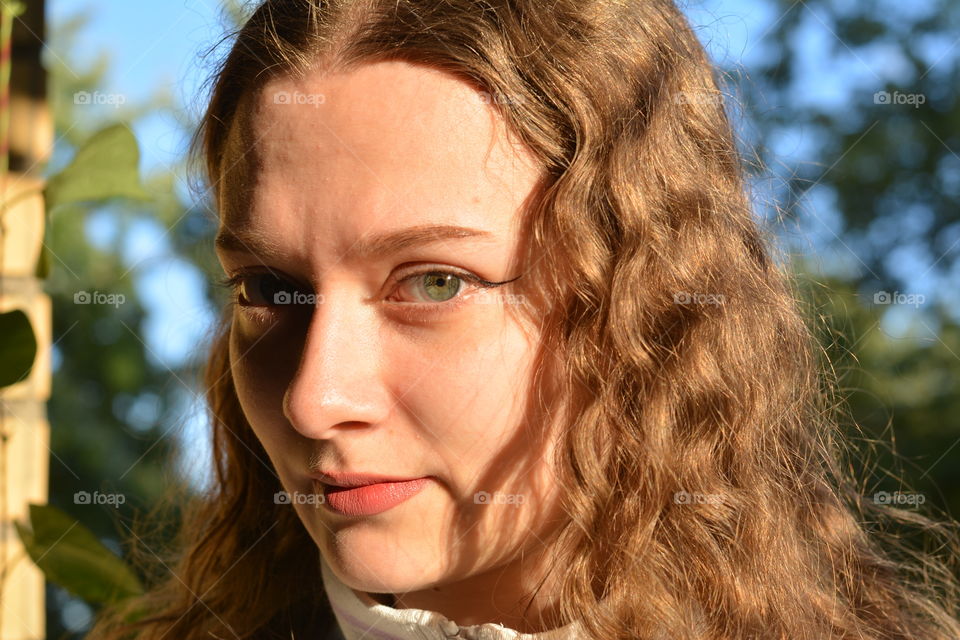 brunette girl beautiful portrait in sunlight outdoor