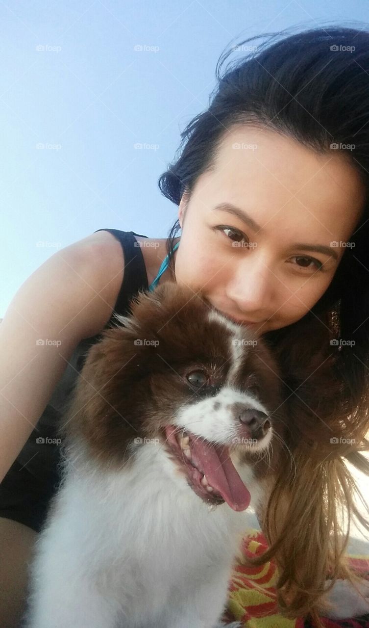 A pom and her mom at the beach. A simple relaxing sunny day at Huntington beach with Pumpkin the pomeranian.