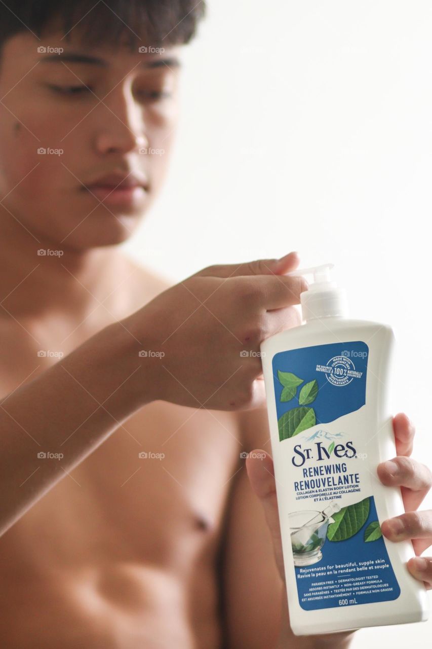 Skin care product in use by a young man