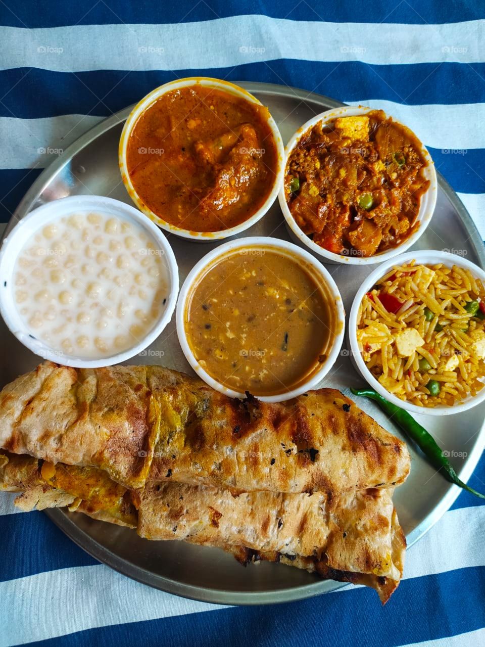 Thali (meaning "plate") is a round platter used to serve food in the Indian subcontinent and Southeast Asia. Thali is also used to refer to an Indian-style meal made up of a selection of various dishes which are served on a platter.