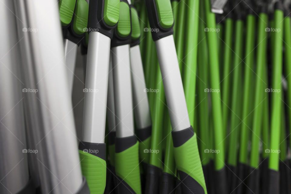 Close up of  garden scissors for trimming bushes . Green rubber handles of  big gardening scissors