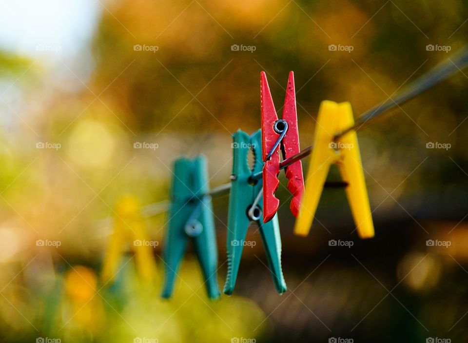 Colorful clothes pegs on a rope