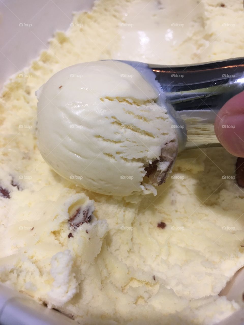 Scooping butter pecan ice cream