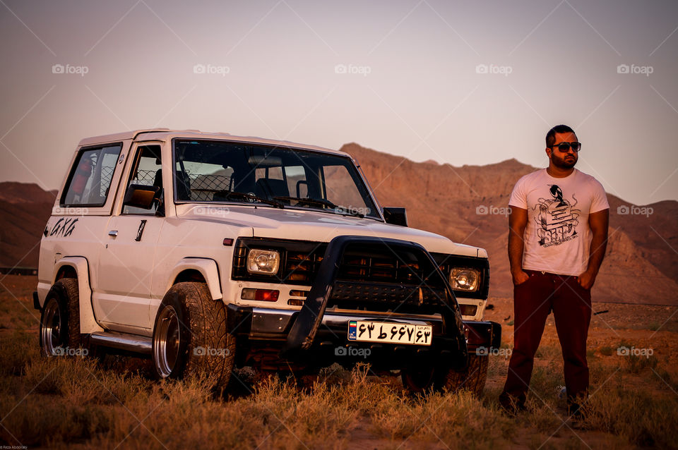 guy and his power. Offroad trip to the desert with a handsome guy and his powerful patrol at sunset.