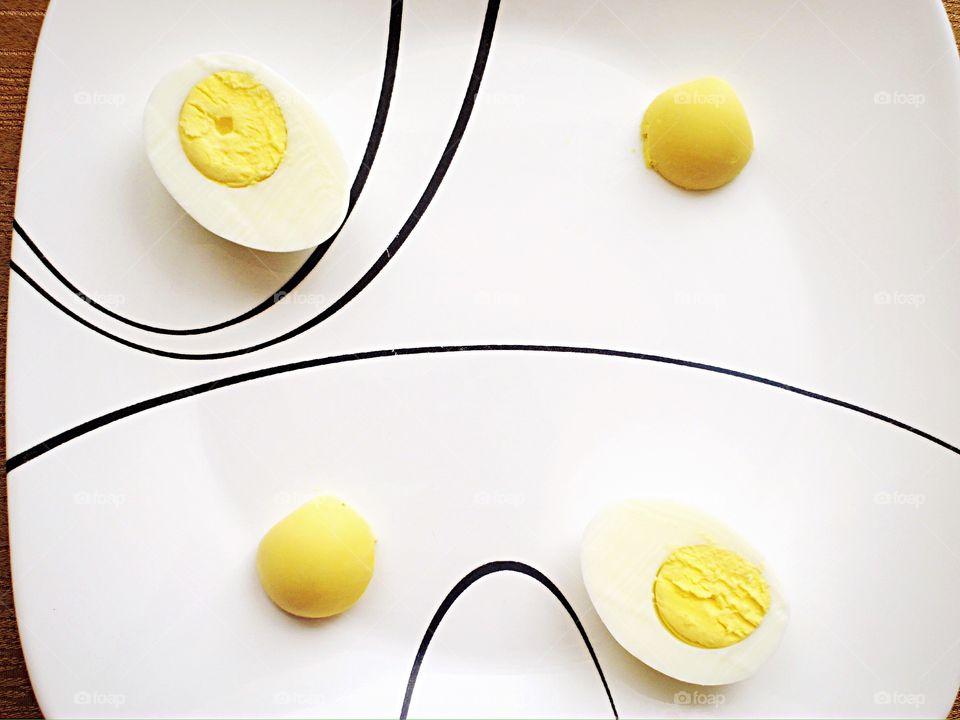 Boiled eggs and yolks on plate